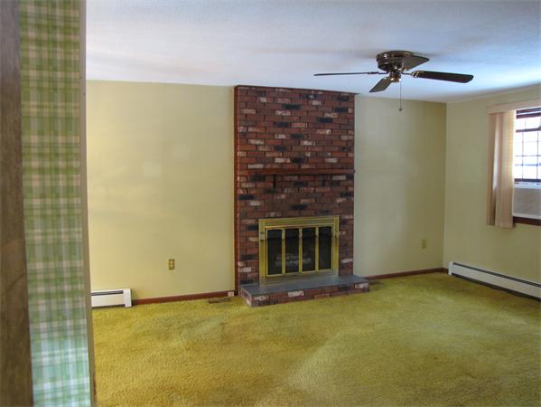 31 Wilbraham Road Hampden, MA 01036 - Photo 5 of 19 a view of an empty room with a fireplace and a window