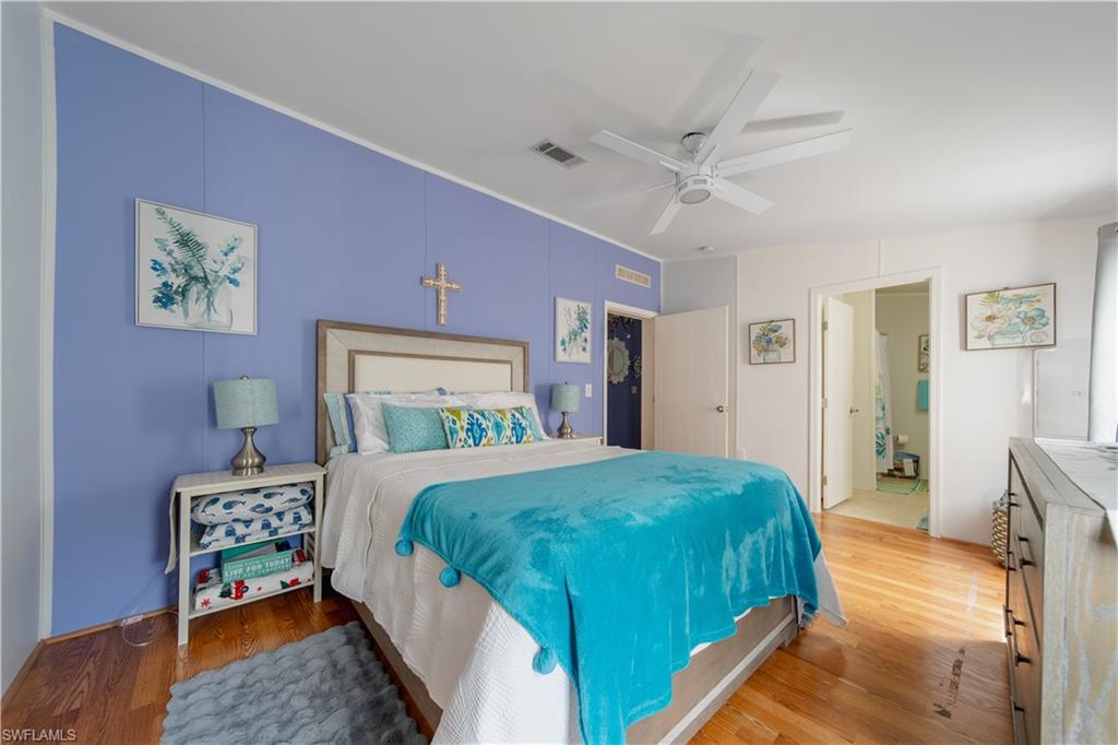 433 Riviera Boulevard West Naples, FL 34112 - Photo 11 of 30 a bedroom with a bed and a table