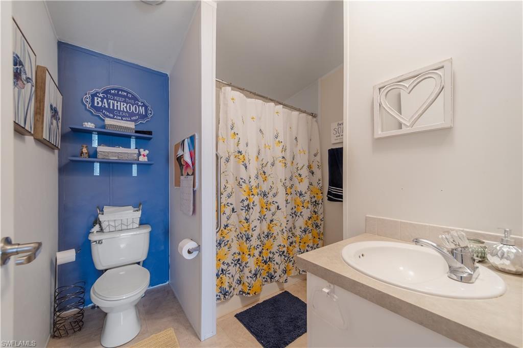 433 Riviera Boulevard West Naples, FL 34112 - Photo 19 of 30 a bathroom with a sink toilet and shower