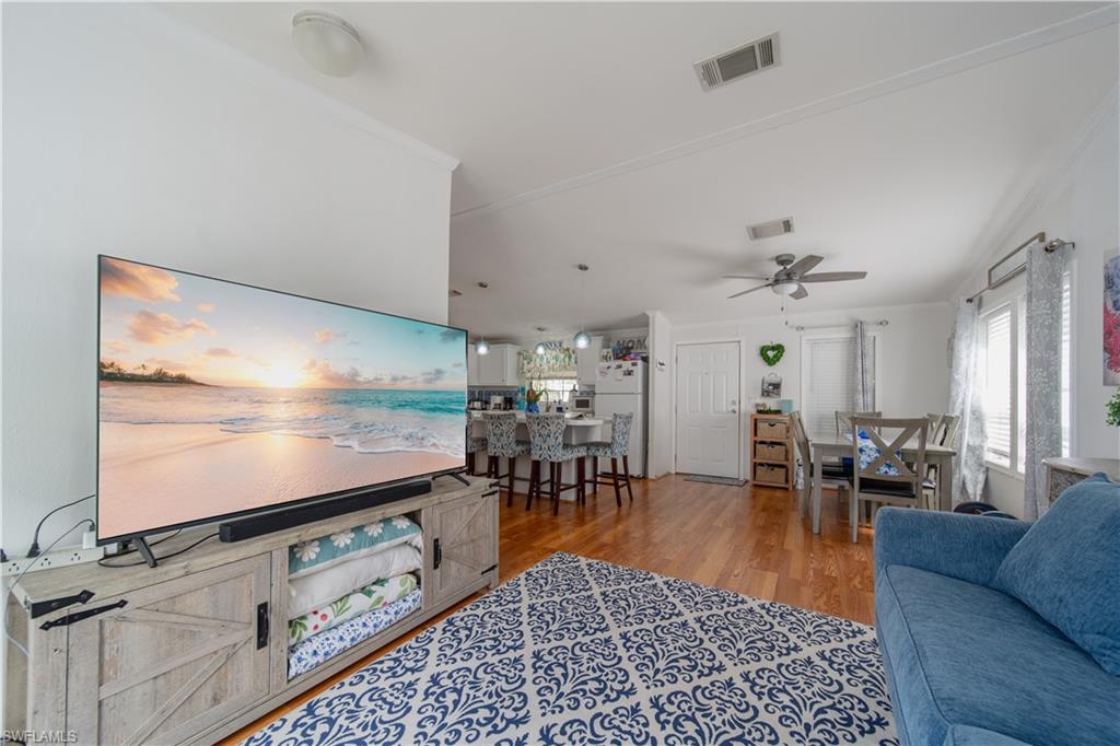 433 Riviera Boulevard West Naples, FL 34112 - Photo 2 of 30 a living room with furniture and a flat screen tv