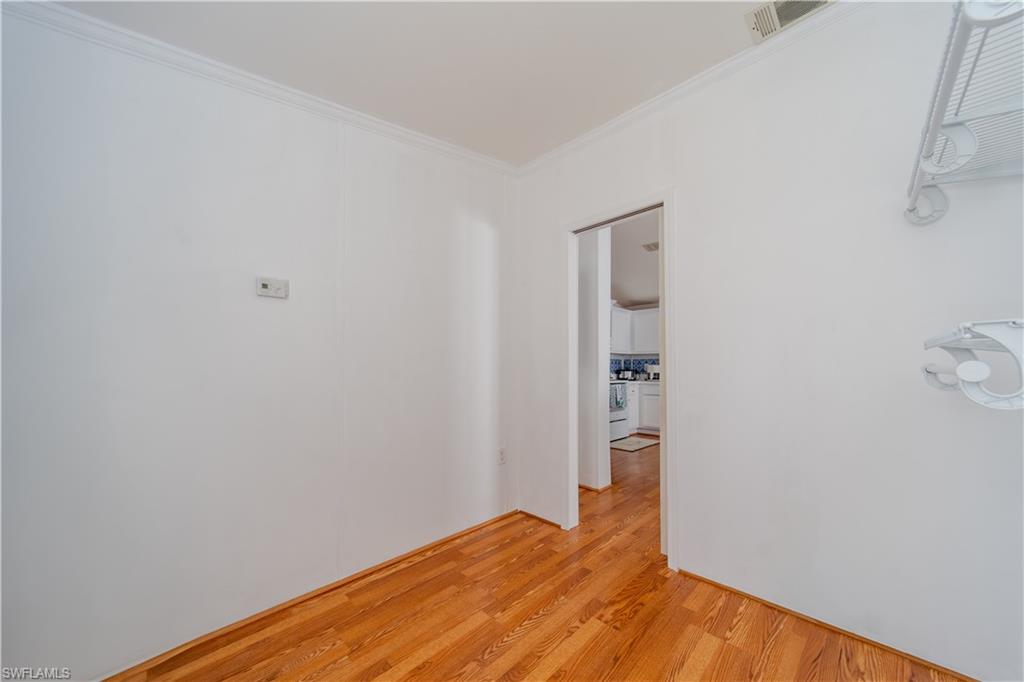 433 Riviera Boulevard West Naples, FL 34112 - Photo 21 of 30 a view of empty room with wooden floor