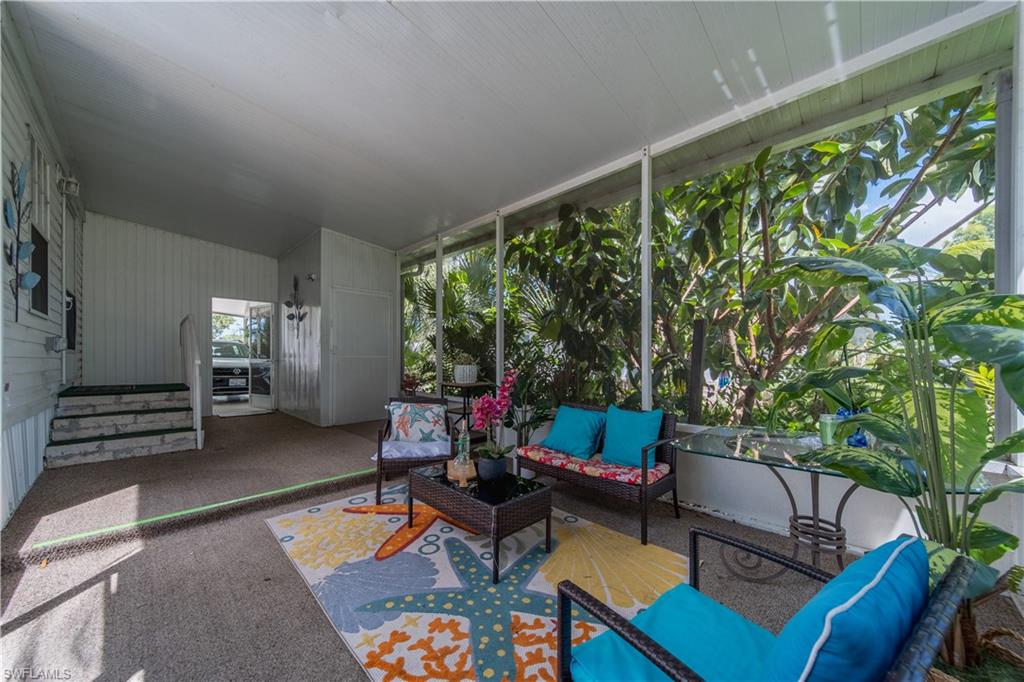 433 Riviera Boulevard West Naples, FL 34112 - Photo 25 of 30 a living room with furniture and a large window