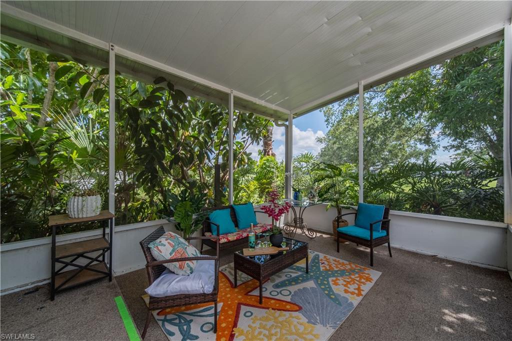 433 Riviera Boulevard West Naples, FL 34112 - Photo 26 of 30 a outdoor living space with furniture and garden view