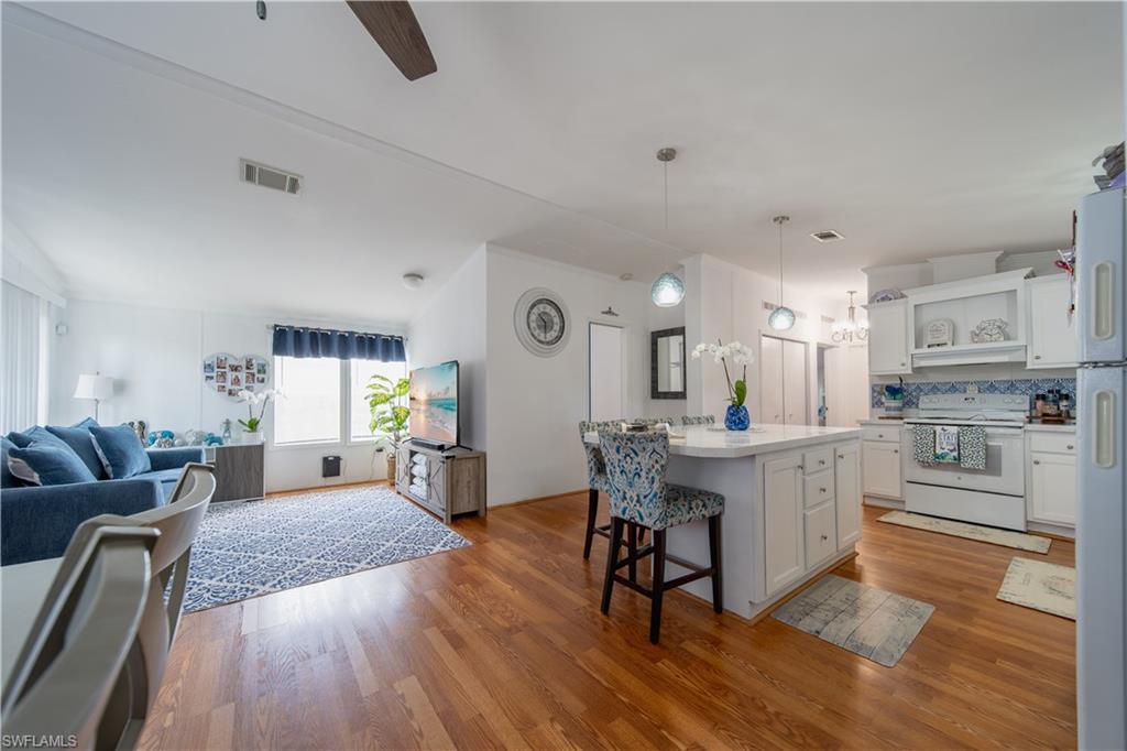 433 Riviera Boulevard West Naples, FL 34112 - Photo 30 of 30 a living room with furniture and kitchen view