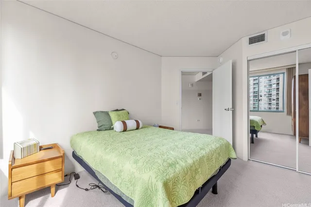 a bedroom with a bed and table