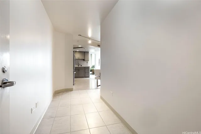 a view of a kitchen with a sink and a refrigerator