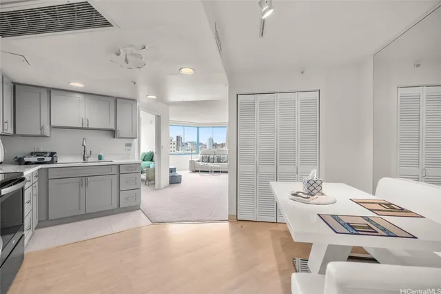a kitchen with a table chairs microwave and cabinets