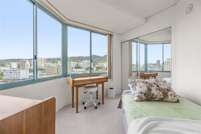 a living room with furniture and large windows