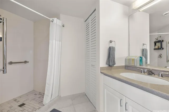 a bathroom with a granite countertop sink and a mirror