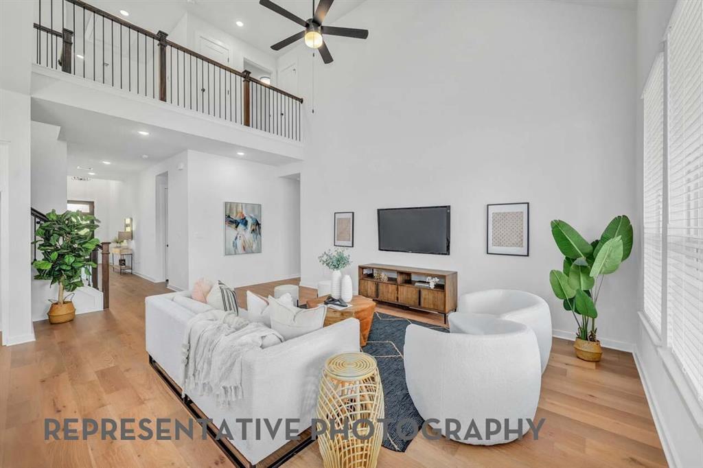 8715 Wildberry Road Oak Point, TX 75068 - Photo 7 of 23 a living room with furniture or wooden floor and a potted plant
