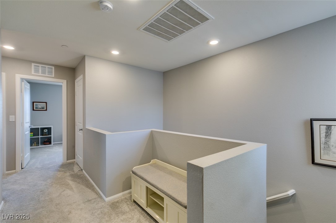 2870 Turnstone Ridge Street Henderson, NV 89044 - Photo 28 of 50 Hallway with light colored carpet, an upstairs landing, recessed lighting, and baseboards