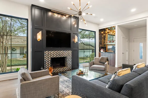 a living room with furniture fireplace and a large window