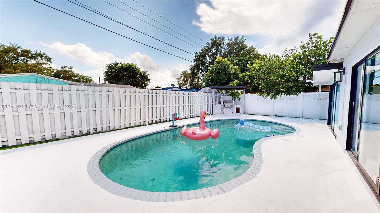 6630 Cody Street Hollywood, FL 33024 - Photo 2 of 45 a view of a swimming pool with an outdoor seating area