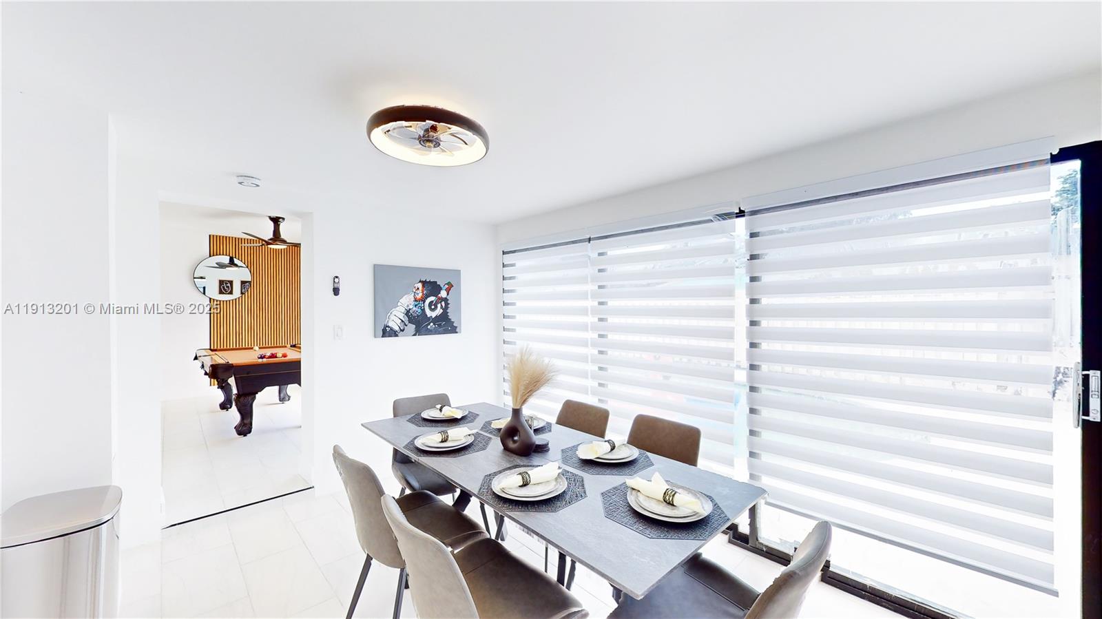 6630 Cody Street Hollywood, FL 33024 - Photo 22 of 45 a view of a dining room with furniture and a chandelier