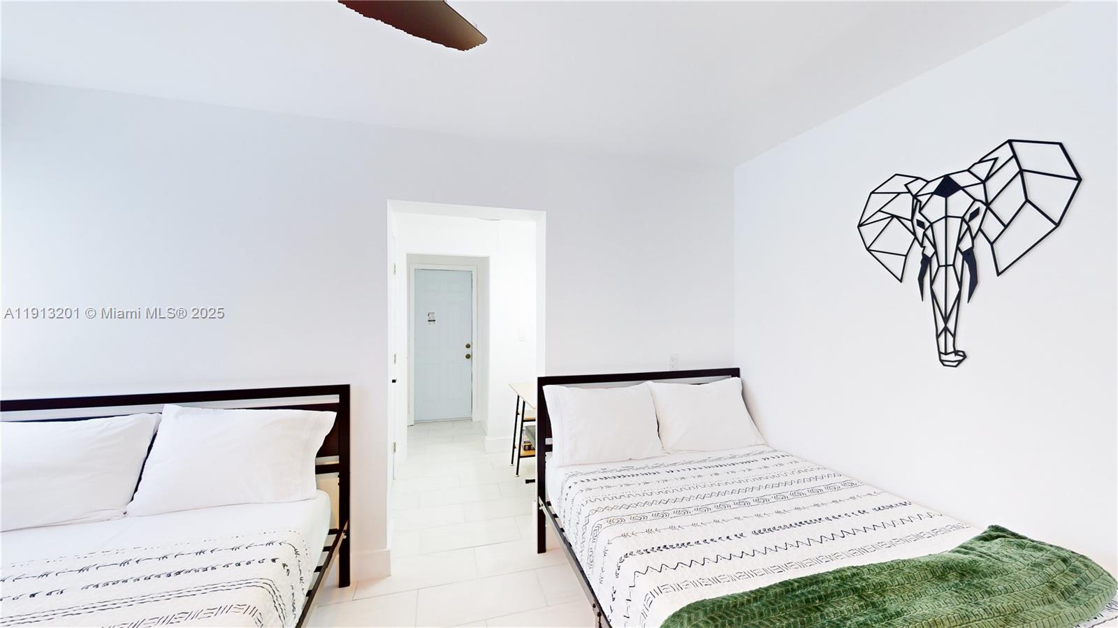 6630 Cody Street Hollywood, FL 33024 - Photo 24 of 45 a bedroom with a white bed and dresser