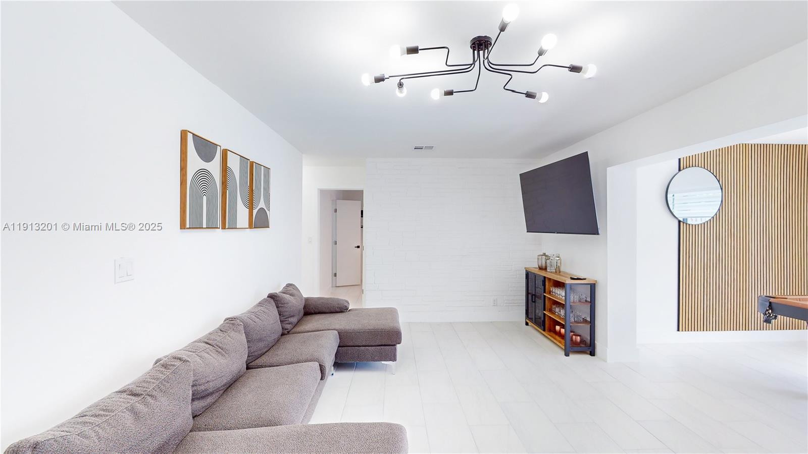 6630 Cody Street Hollywood, FL 33024 - Photo 25 of 45 a living room with furniture and a flat screen tv