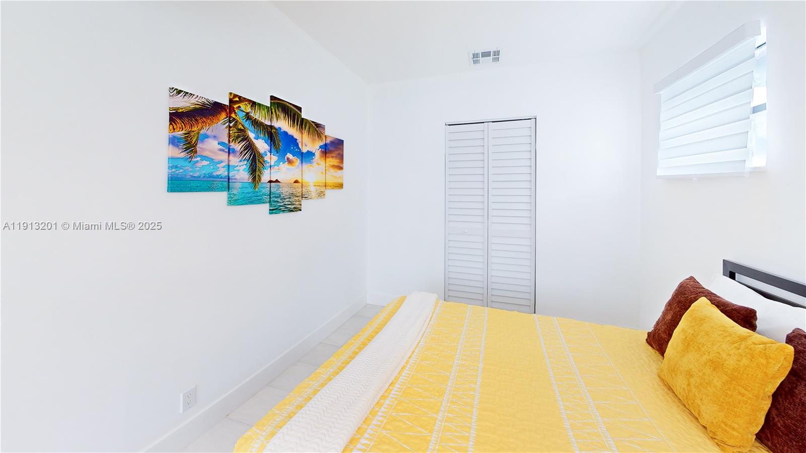 6630 Cody Street Hollywood, FL 33024 - Photo 36 of 45 a bedroom with a bed and a painting on the wall