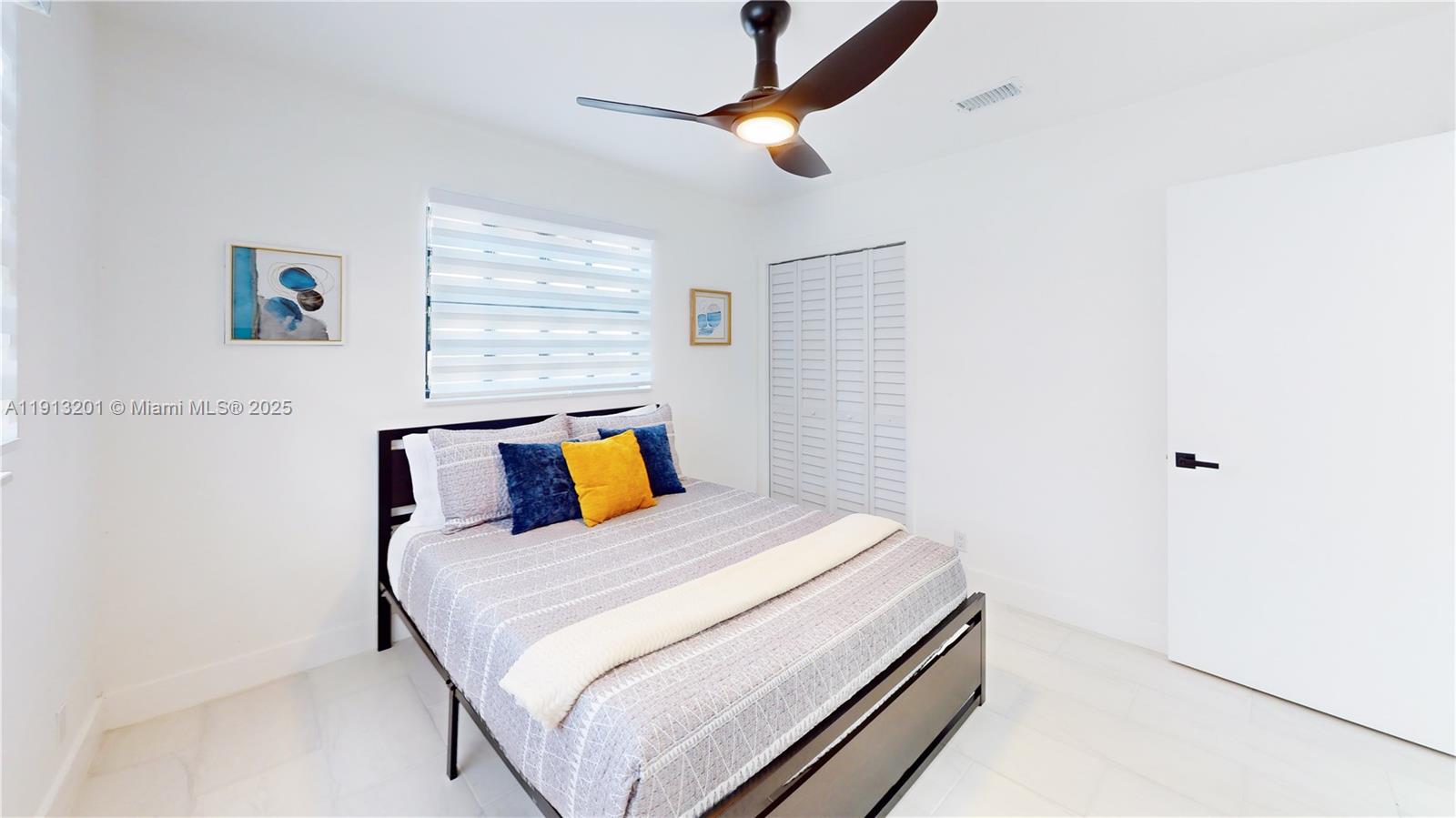 6630 Cody Street Hollywood, FL 33024 - Photo 41 of 45 a bedroom with a bed and a wall painting