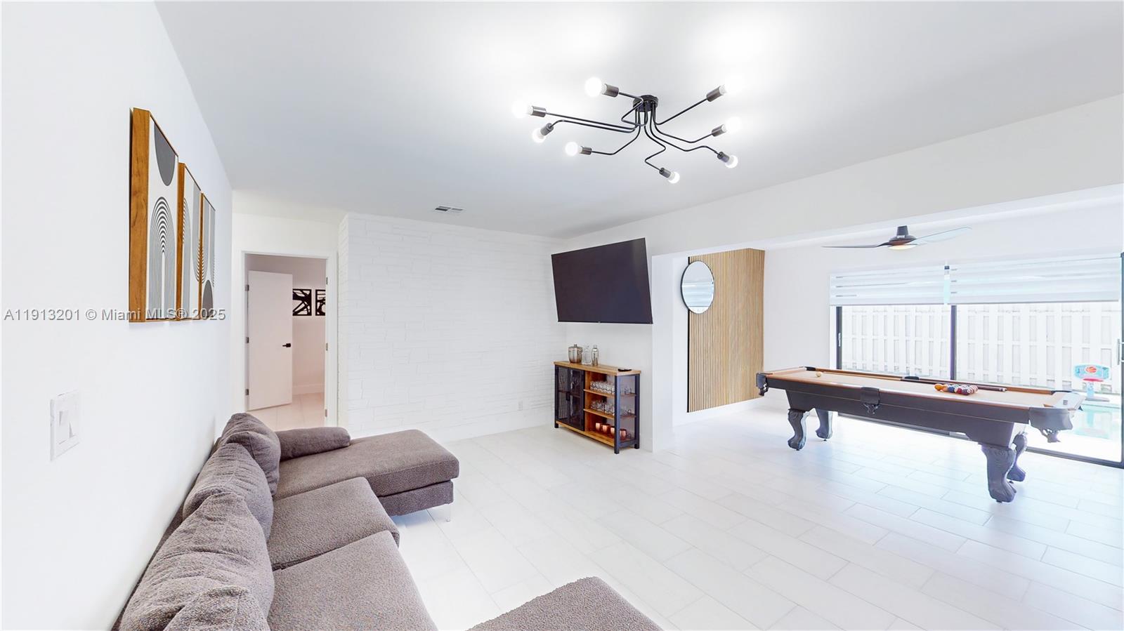 6630 Cody Street Hollywood, FL 33024 - Photo 9 of 45 a living room with furniture and a flat screen tv