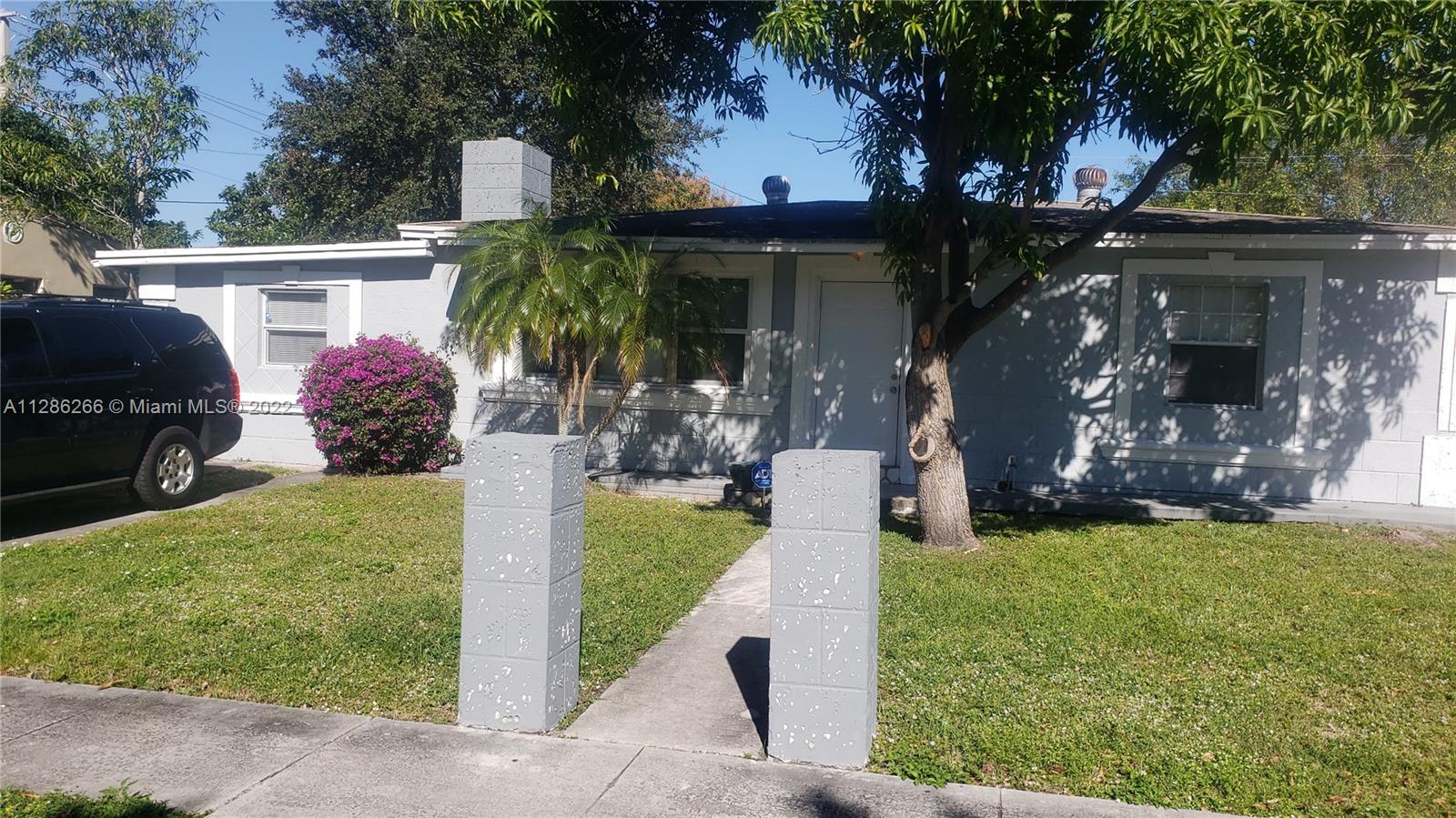 559 Dogwood Road West Palm Beach, FL 33409 - Photo 1 of 7 a front view of a house with garden
