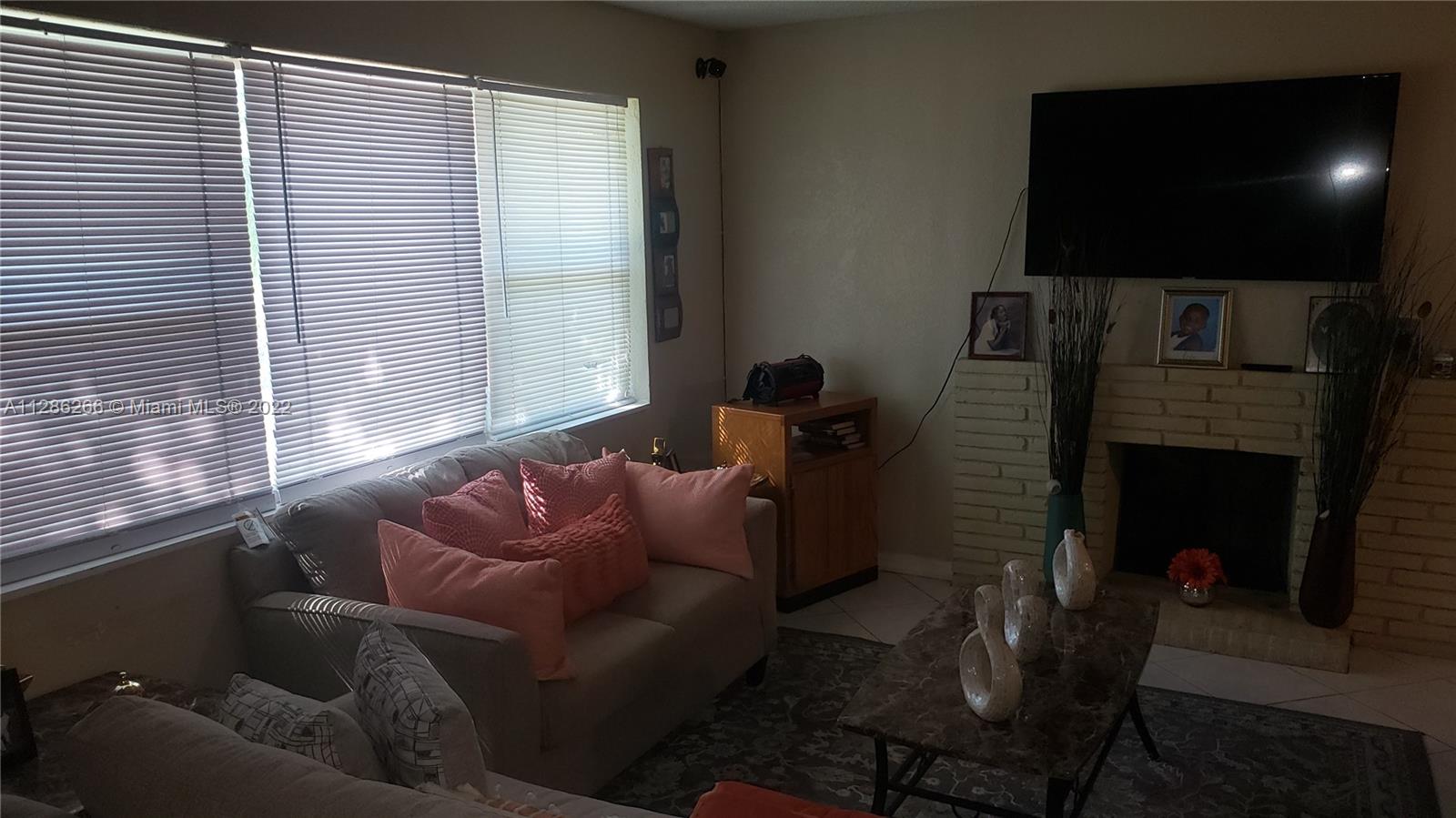 559 Dogwood Road West Palm Beach, FL 33409 - Photo 2 of 7 a living room with furniture and a flat screen tv