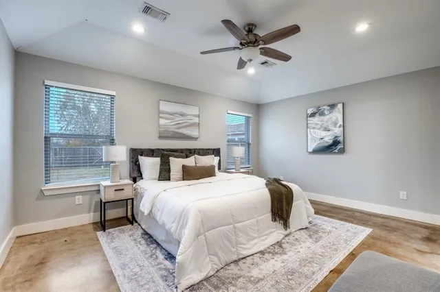 a bedroom with a large bed and a window