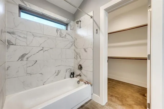 a bathroom with a bathtub and shower