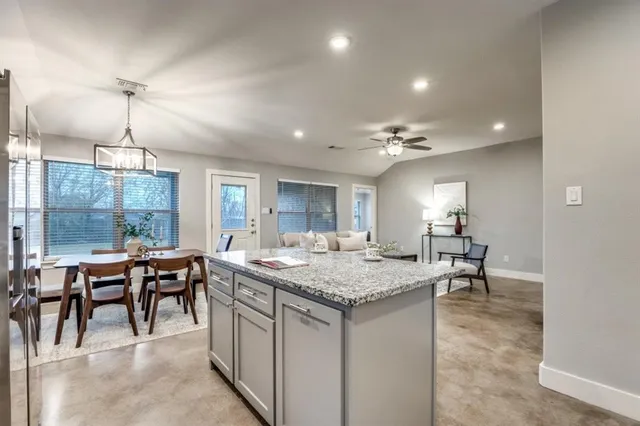 a open kitchen with a table and chairs