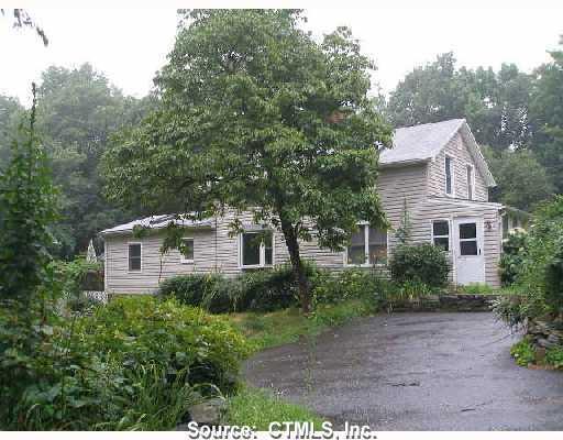 158 Summit Road Prospect, CT 06712 - Photo 1 of 1 a front view of a house with a yard and trees