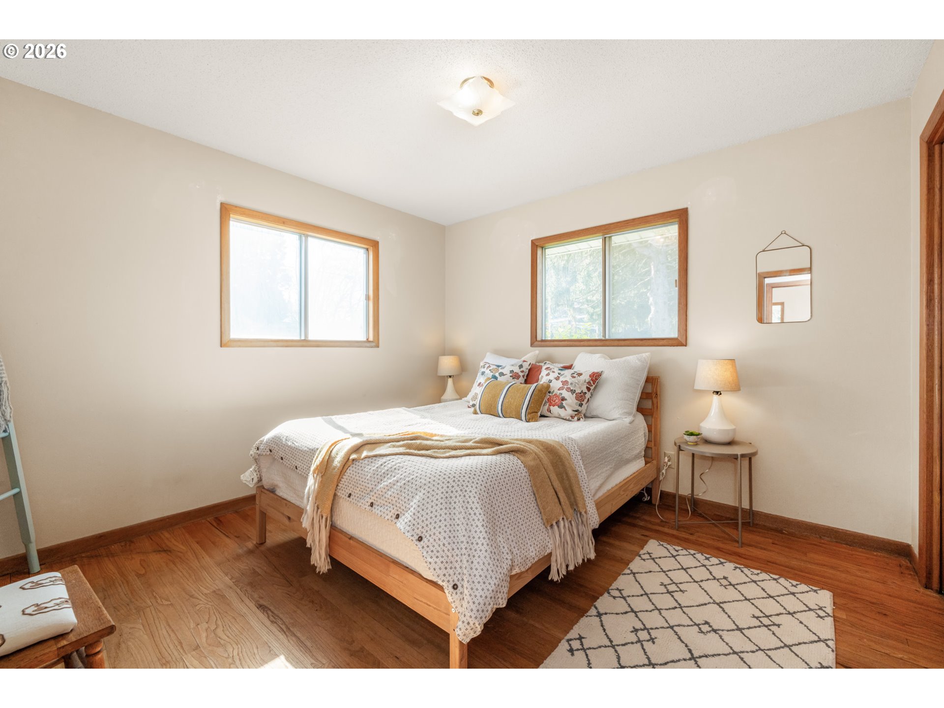 9025 Southwest Avery Street Tualatin, OR 97062 - Photo 14 of 35 a bedroom with a bed and a painting on the wall