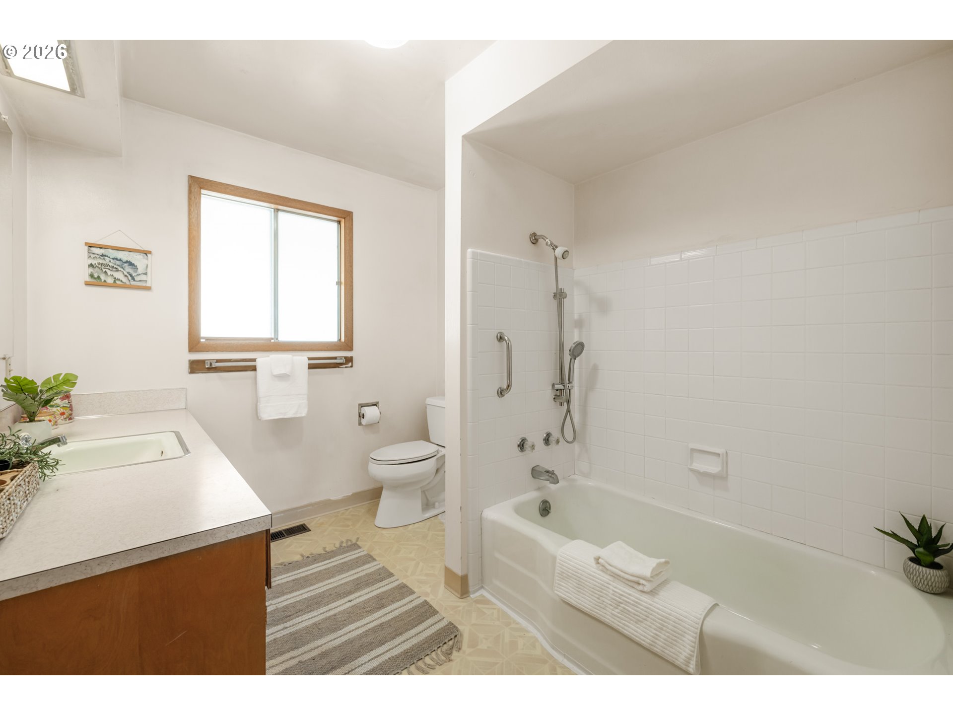 9025 Southwest Avery Street Tualatin, OR 97062 - Photo 19 of 35 a bathroom with a sink a toilet and a bathtub
