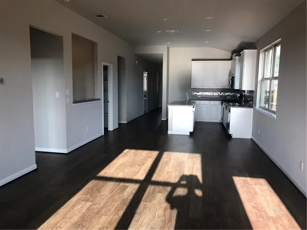 a living room with furniture wooden floor and a rug
