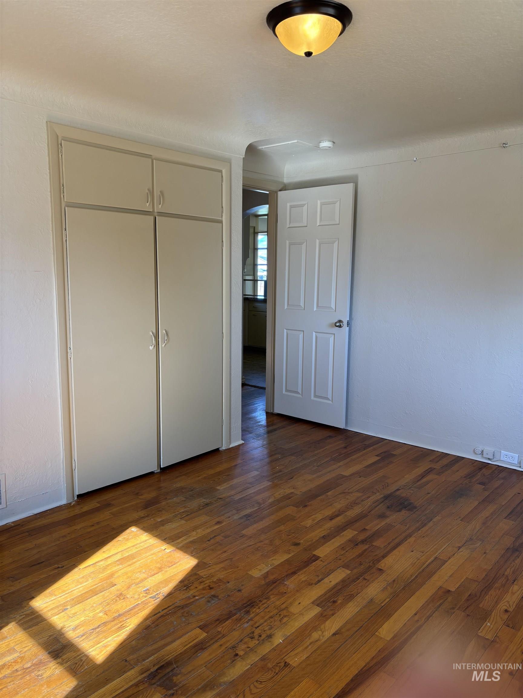 5116 West Morris Hill Road Boise, ID 83706 - Photo 12 of 19 Wood-finish flooring complemented by a built-in storage unit with upper cabinetry