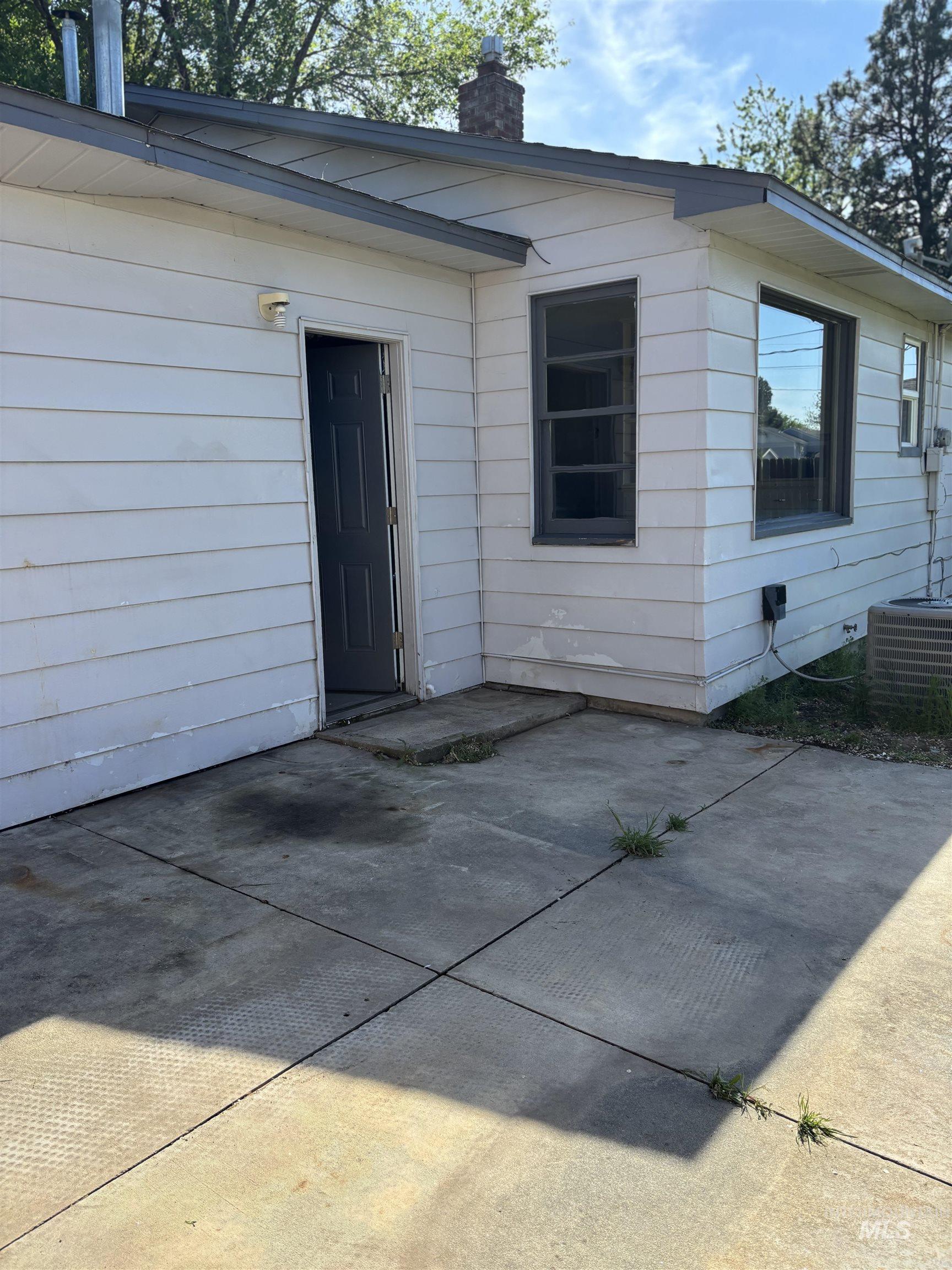 5116 West Morris Hill Road Boise, ID 83706 - Photo 14 of 19 White siding exterior with a concrete patio