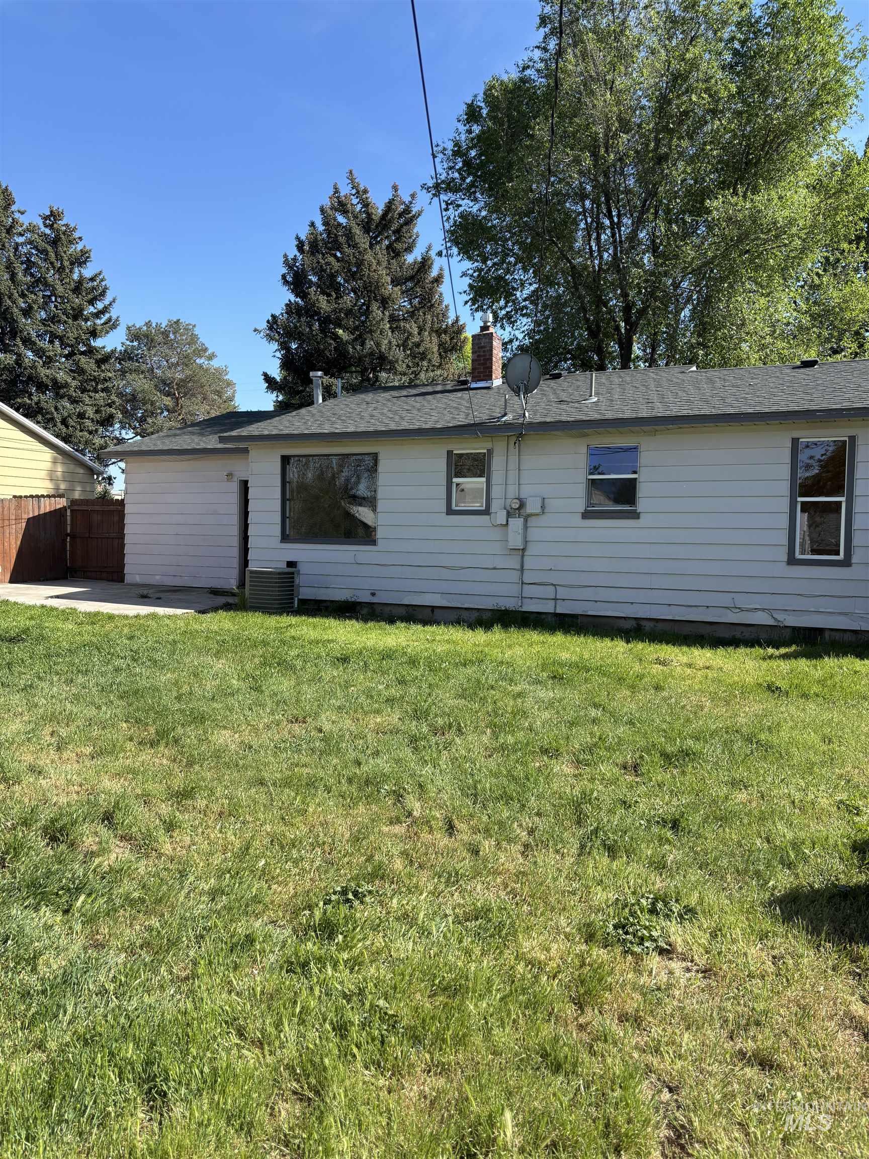 5116 West Morris Hill Road Boise, ID 83706 - Photo 15 of 19 Expansive grassy yard with mature trees and a partial wood fence