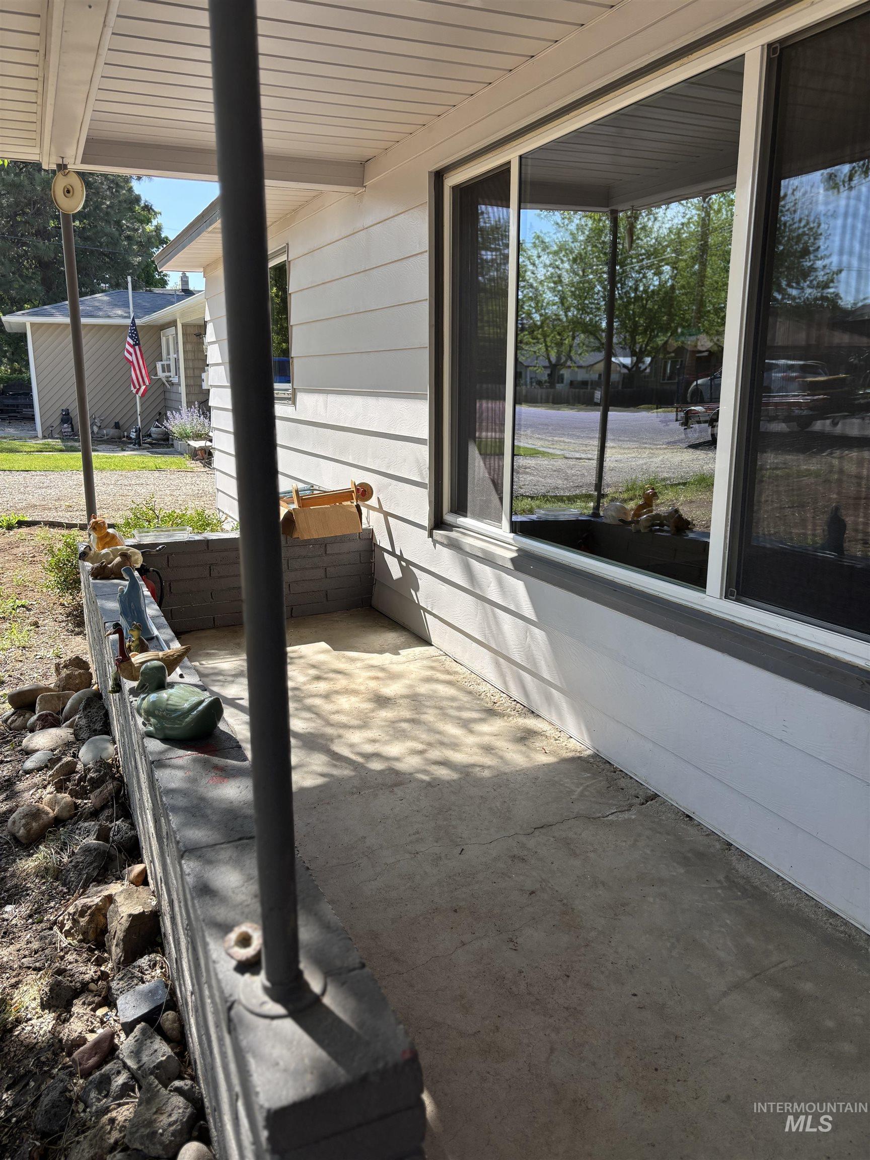5116 West Morris Hill Road Boise, ID 83706 - Photo 2 of 19 Covered porch with horizontal siding, large window, and concrete flooring