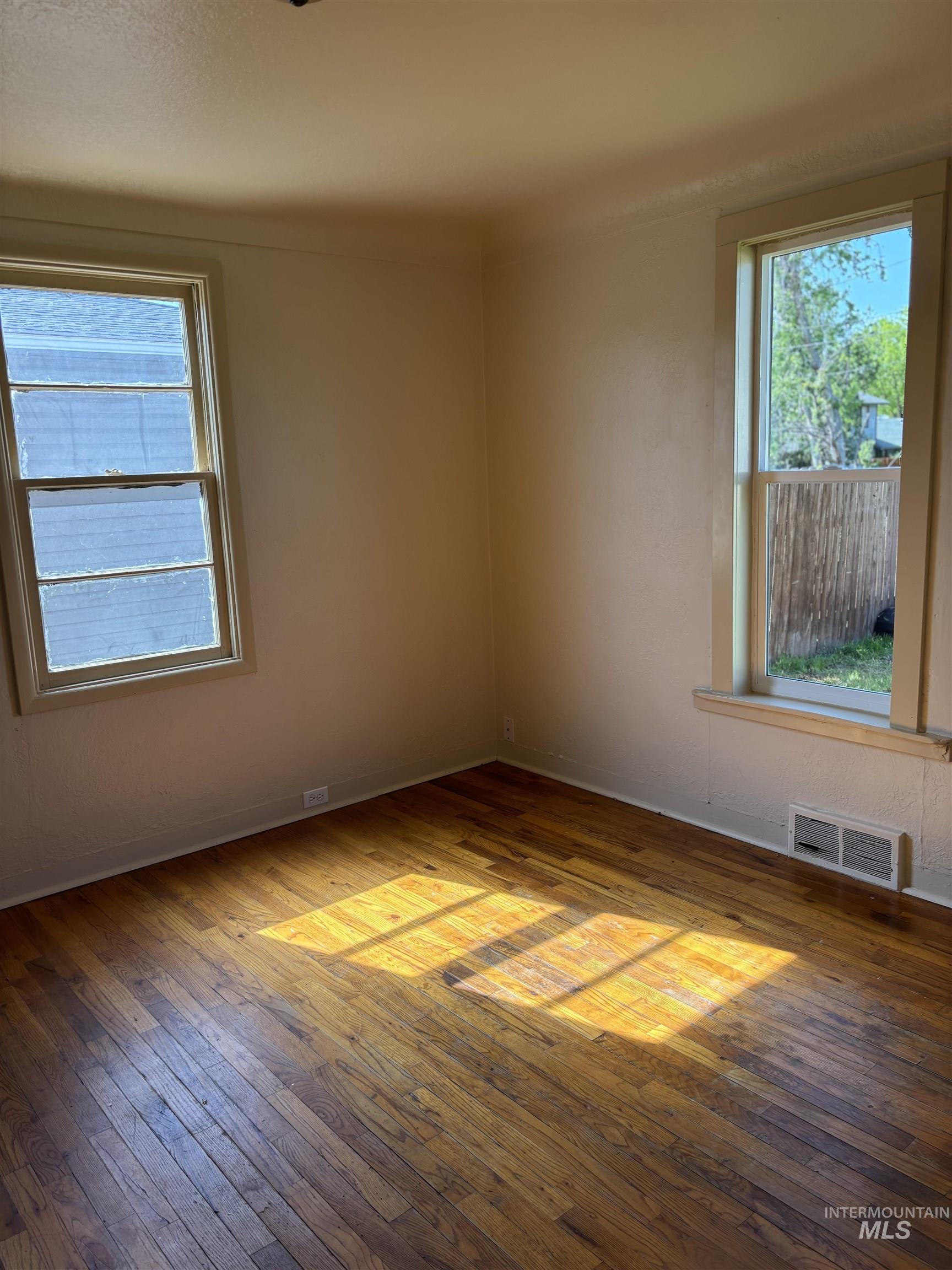 5116 West Morris Hill Road Boise, ID 83706 - Photo 8 of 19 Wood-finish flooring throughout, complemented by two windows providing natural illumination