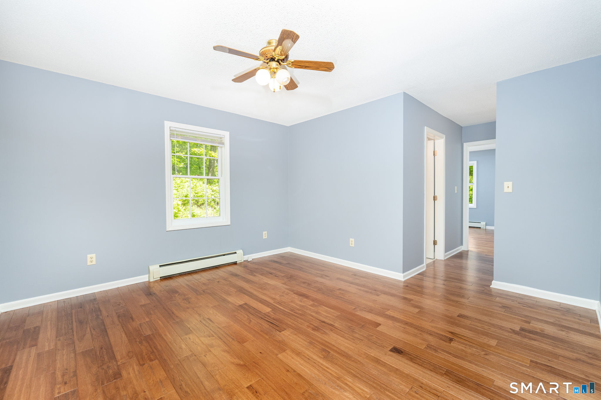 175 Vernon Street Manchester, CT 06042 - Photo 11 of 38 a view of an empty room with a window and wooden floor