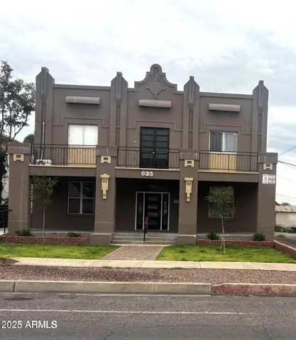 a view of a brick building next to a yard
