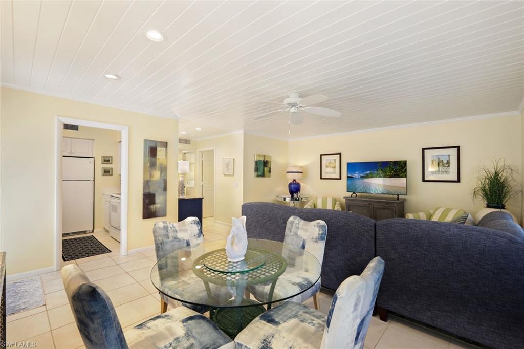 286 4th Street South, Unit 203 Naples, FL 34102 - Photo 5 of 25 a living room with furniture and wooden floor