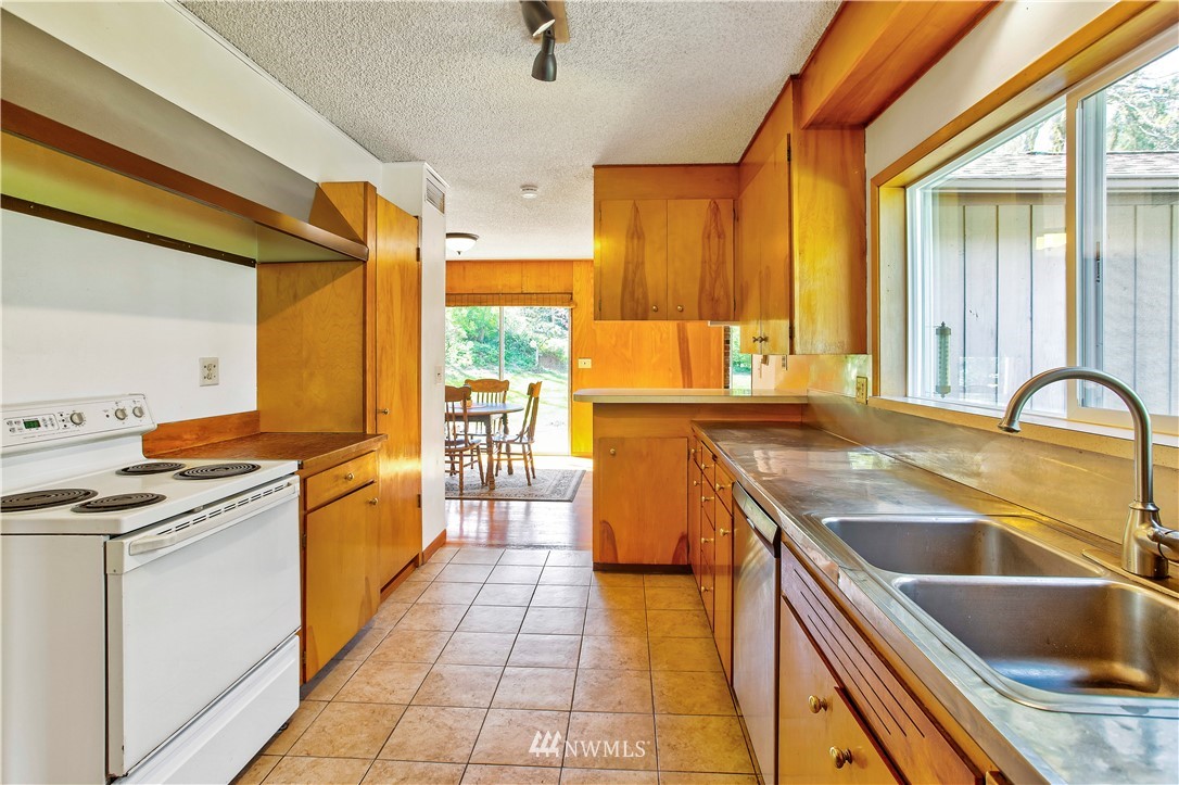 16919 112th Place Northeast Bothell, WA 98011 - Photo 12 of 40 a kitchen with stainless steel appliances granite countertop a sink and a stove