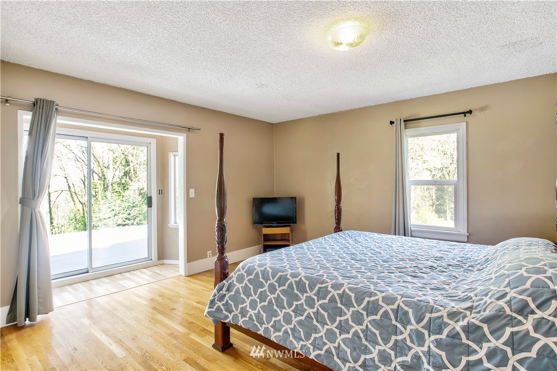 16919 112th Place Northeast Bothell, WA 98011 - Photo 14 of 40 a bedroom with a large bed and a large window