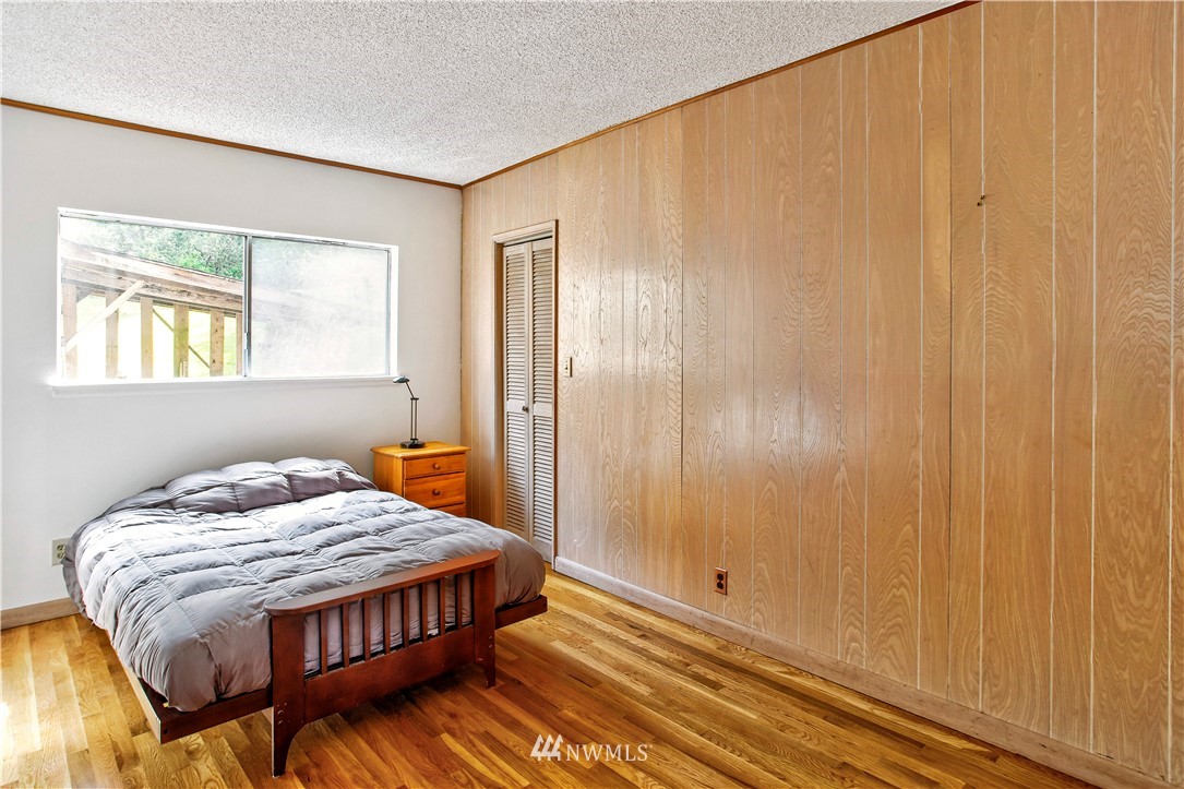 16919 112th Place Northeast Bothell, WA 98011 - Photo 18 of 40 a bedroom with a bed and wooden floor