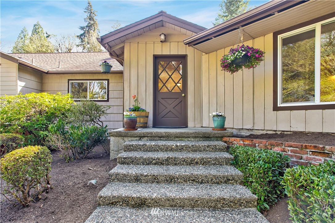 16919 112th Place Northeast Bothell, WA 98011 - Photo 4 of 40 a front view of a house with a garden