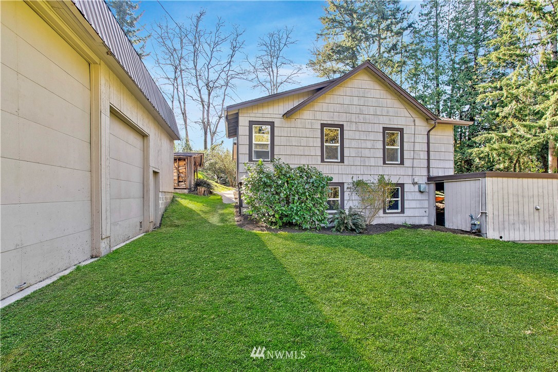 16919 112th Place Northeast Bothell, WA 98011 - Photo 31 of 40 a view of a yard in front of a house with plants and large tree