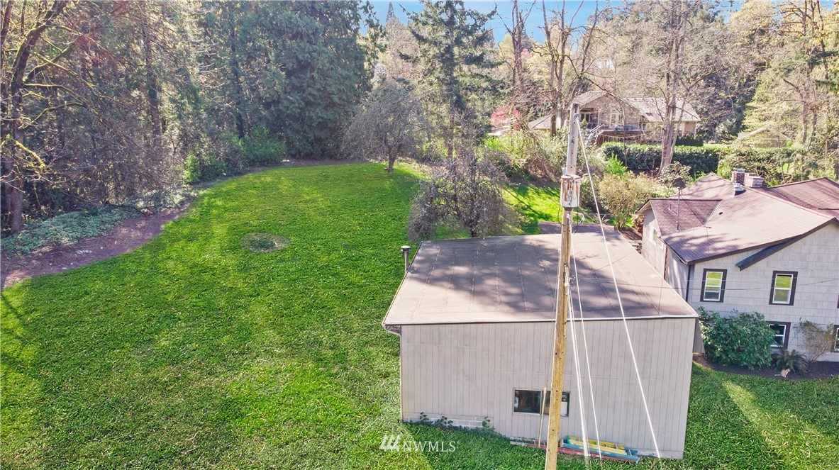 16919 112th Place Northeast Bothell, WA 98011 - Photo 36 of 40 a white house with a small yard and large trees