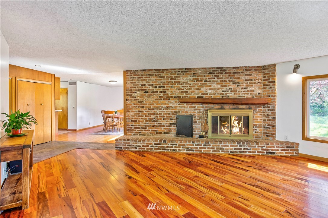16919 112th Place Northeast Bothell, WA 98011 - Photo 7 of 40 a view of a livingroom with wooden floor and a fireplace
