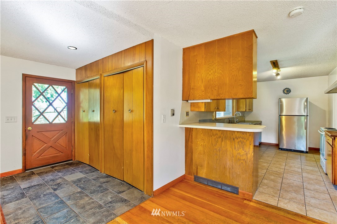 16919 112th Place Northeast Bothell, WA 98011 - Photo 10 of 40 a view of a kitchen with wooden floor and a refrigerator