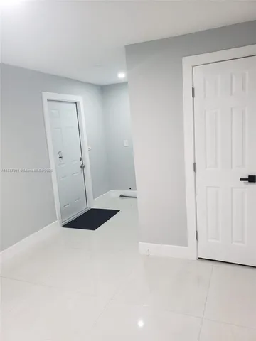 an aerial view of a house with a yard and large tree