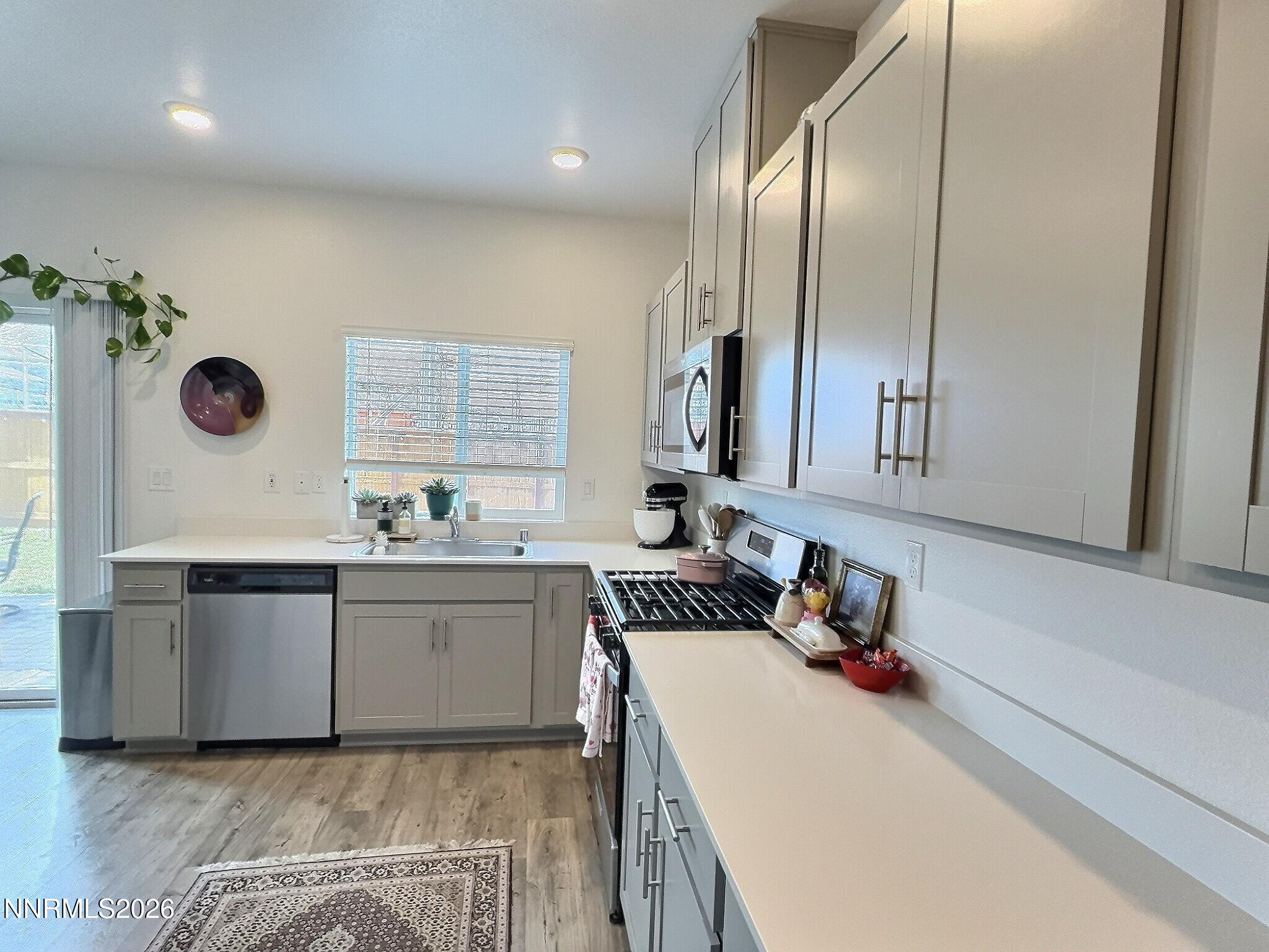 641 Pleasant Vista Drive Reno, NV 89506 - Photo 13 of 30 a kitchen with granite countertop a sink a stove and cabinets